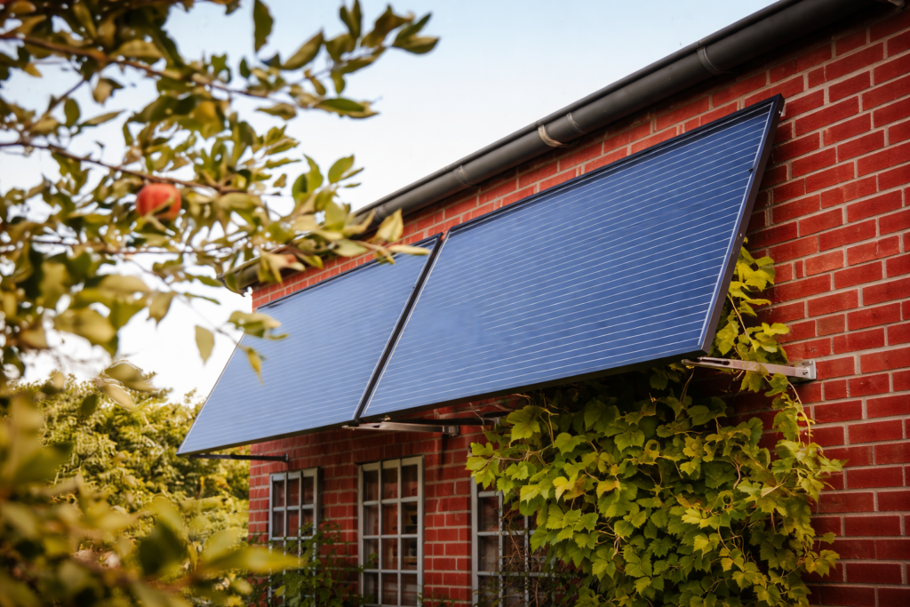 A red brick house with solar panels and green plants representing the green premium property shift and sustainable homes becoming more valuable in Nigeria