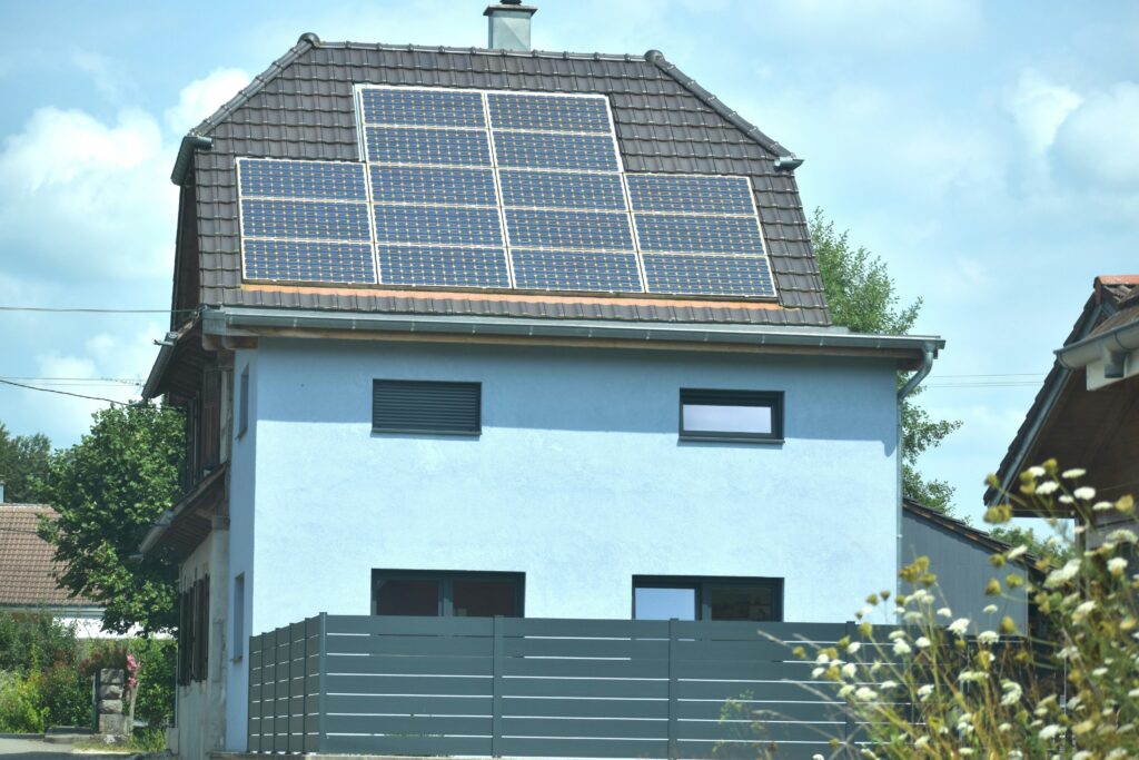 A residential home with solar panels on the rooftop representing off-grid solar energy and sustainable housing like Tamuno Residence in Abuja Nigeria