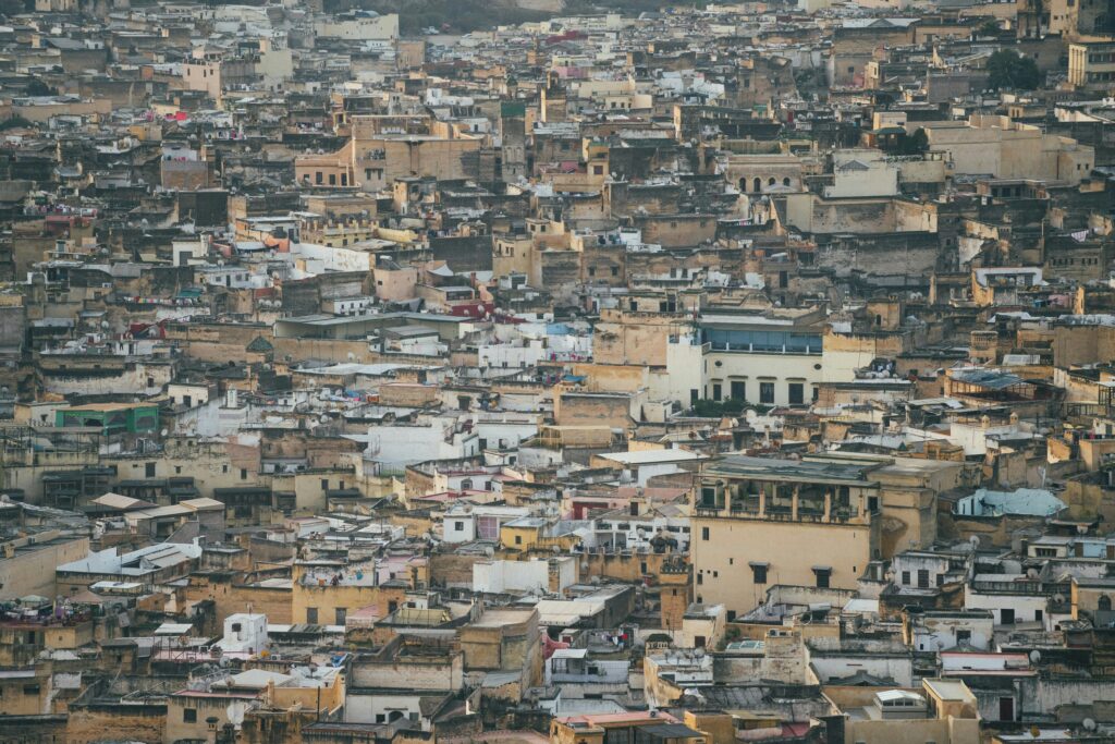 Aerial view of densely packed unplanned buildings representing the need for Enugu building enforcement and land title registration