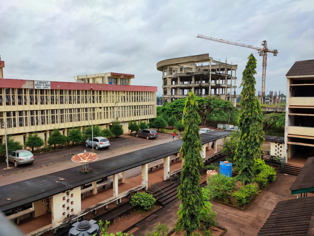 University of Nigeria Enugu Campus with buildings under construction and a crane representing affordable worker housing development and urban growth in Nigeria