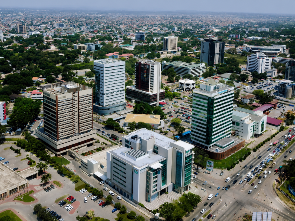 Aerial illustration of a residential and commercial property development beside a highway interchange in Ghana at dusk